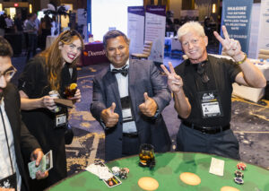 3 conference attendees playing poker