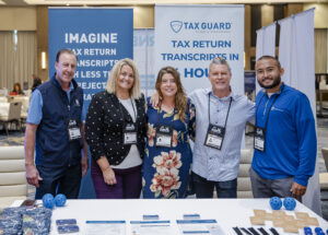 2025 FLAGGL conference attendees posing at tradeshow booth for Tax Guard